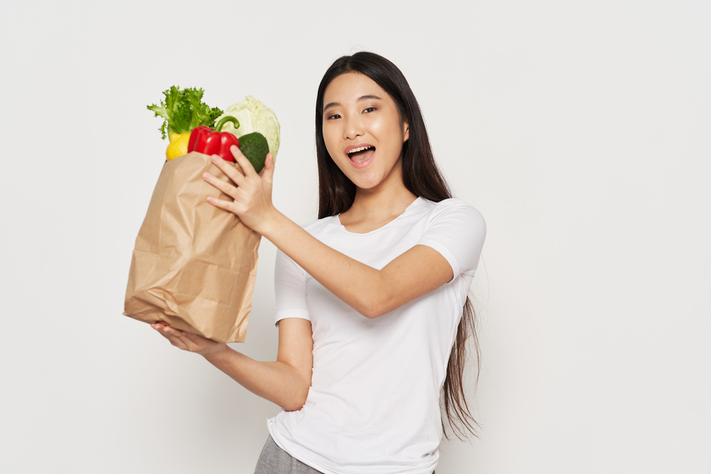 Young Woman Holding Grocery Bag 